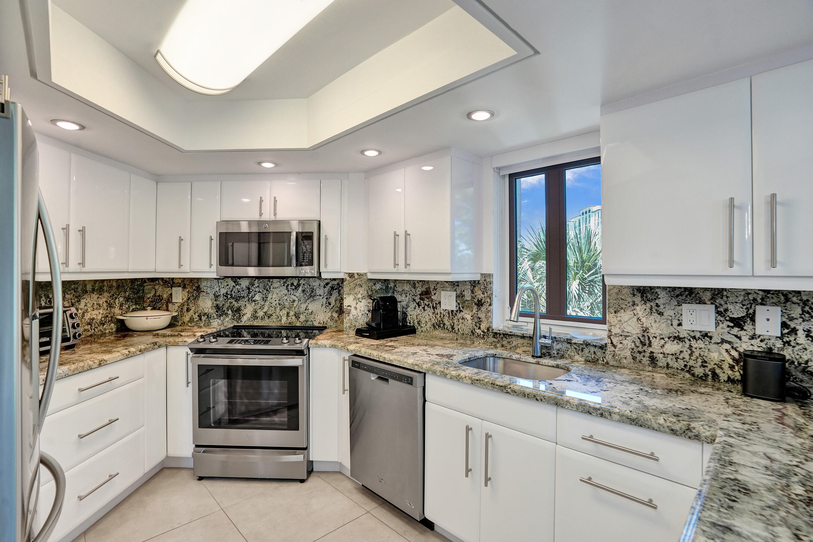 100 Southeast 5th Avenue, Unit 406 Boca Raton, FL 33432 - Photo 9 of 34 a kitchen with a stove sink and cabinets