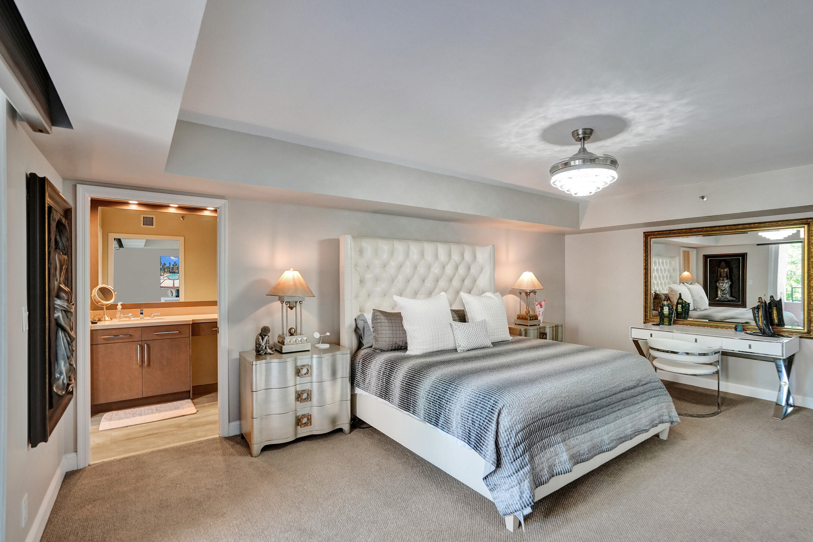 100 Southeast 5th Avenue, Unit 406 Boca Raton, FL 33432 - Photo 10 of 34 a bedroom with bed and a chandelier