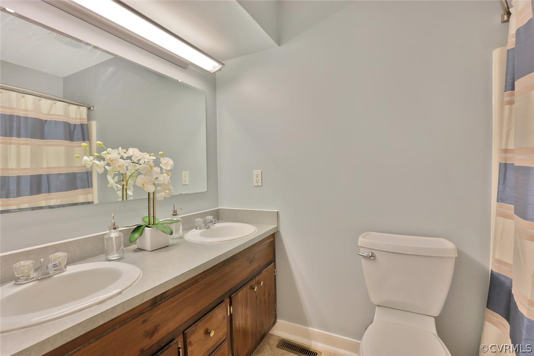 10920 Qualla Road Chesterfield, VA 23832 - Photo 14 of 20 a bathroom with a granite countertop toilet sink and mirror