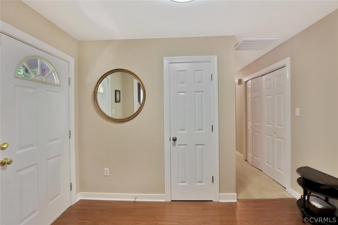 10920 Qualla Road Chesterfield, VA 23832 - Photo 3 of 20 an empty room with wooden floor and mirror