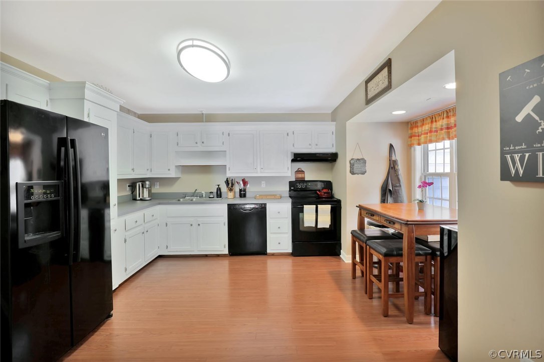 10920 Qualla Road Chesterfield, VA 23832 - Photo 7 of 20 a kitchen with stainless steel appliances a refrigerator a sink a stove a dining table and chairs