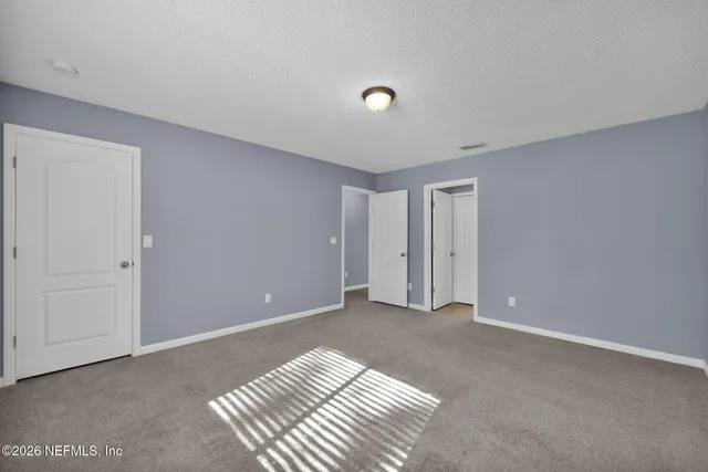 a bathroom with a granite countertop sink toilet a mirror and bathtub