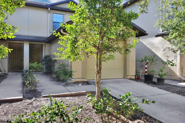 a backyard of a house with fire pit and chairs