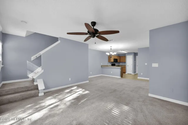 a view of a kitchen with a sink and a chandelier