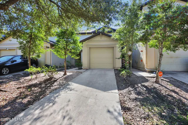 a view of a livingroom with a chandelier fan and windows
