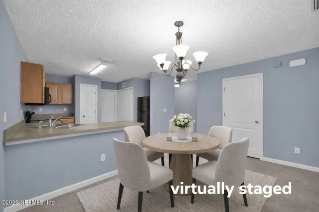 a view of a livingroom with a ceiling fan and window
