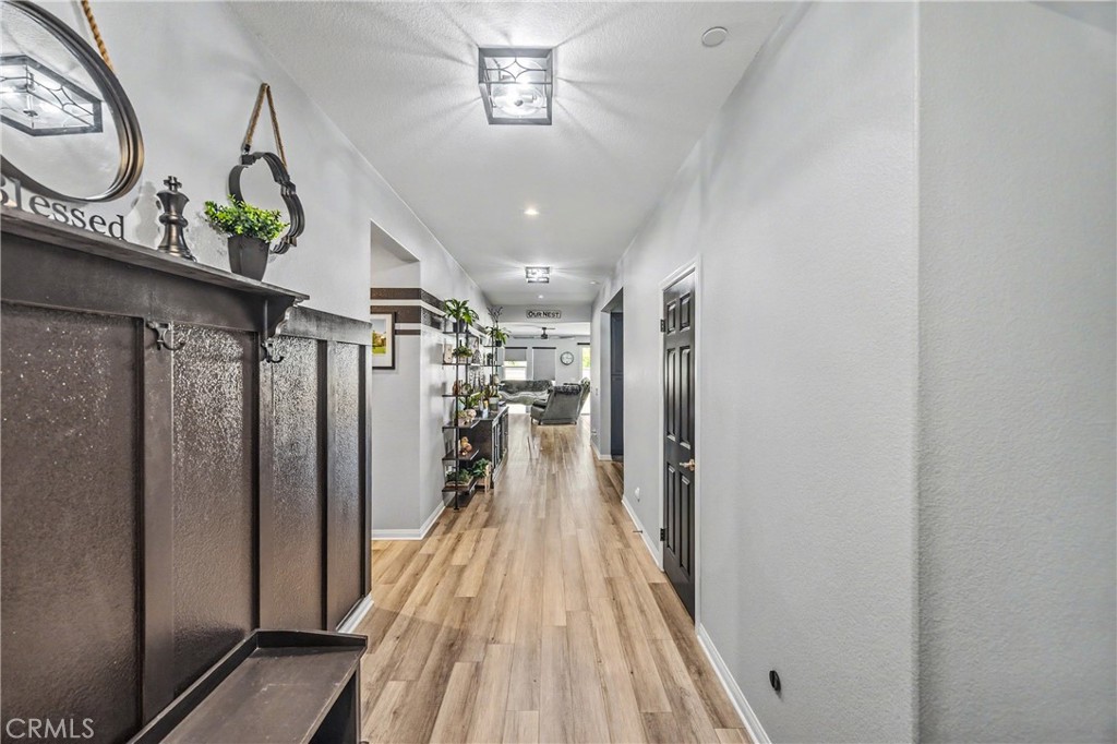 34512 Burnt Pine Road Murrieta, CA 92563 - Photo 13 of 21 a view of a hallway with wooden floor