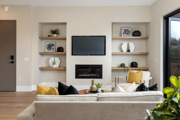 a living room with fireplace and a flat screen tv