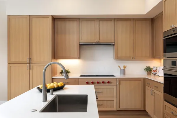 a kitchen with a sink a stove and cabinets