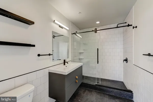 a bathroom with a double vanity sink a mirror and shower