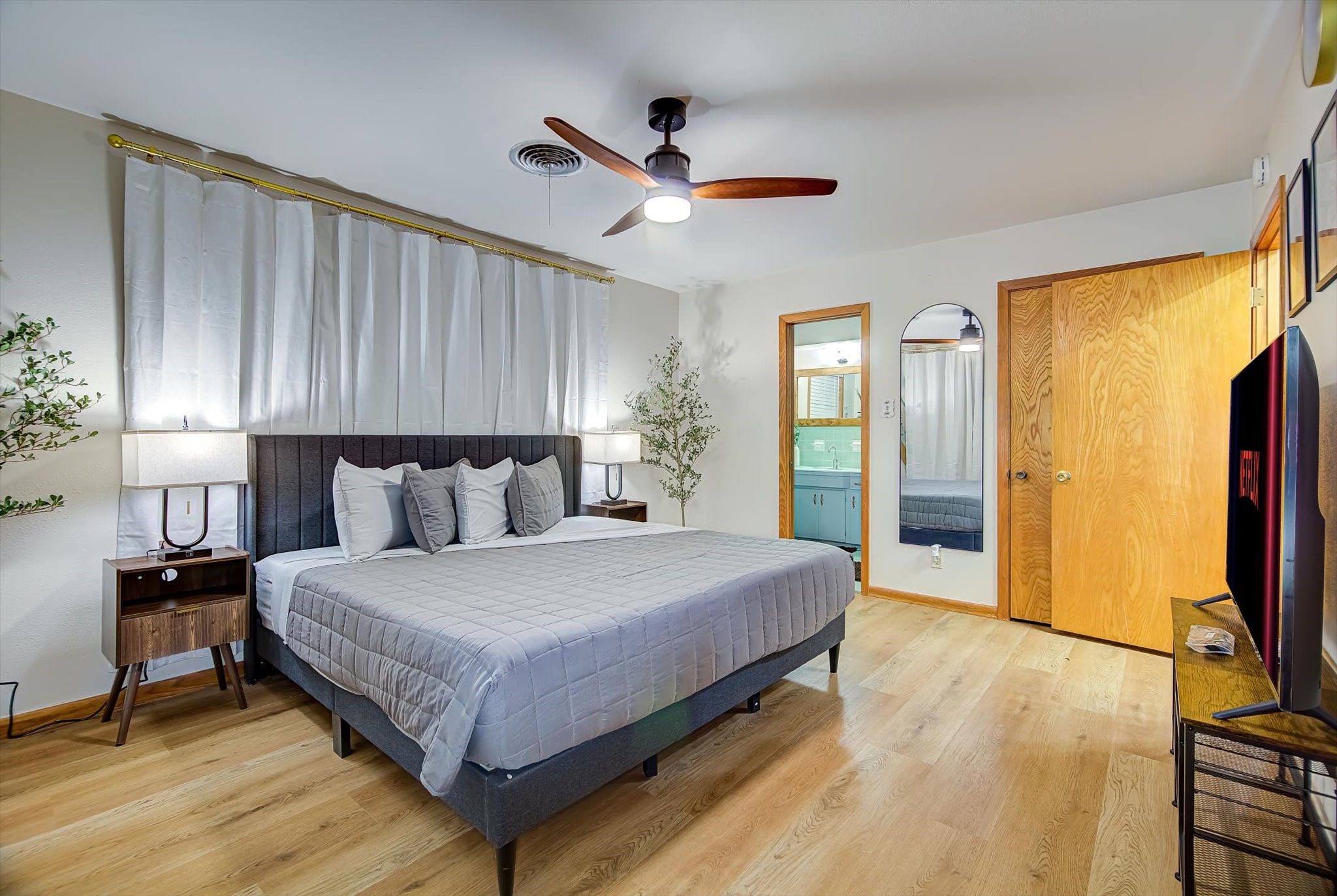 9825 Radio Road Houston, TX 77075 - Photo 17 of 50 a bedroom with a large bed and a flat tv screen on dresser