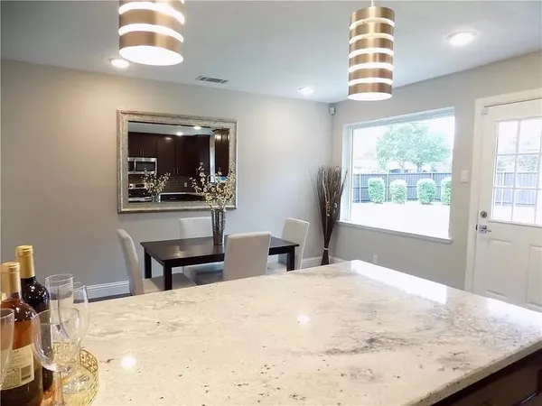 a bedroom with a bed and a dresser with mirror