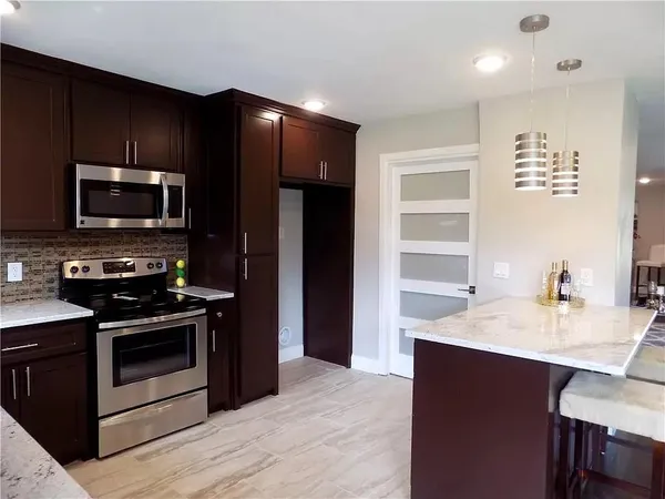 a kitchen with a sink stainless steel appliances and cabinets