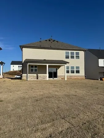 a front view of a house with a road