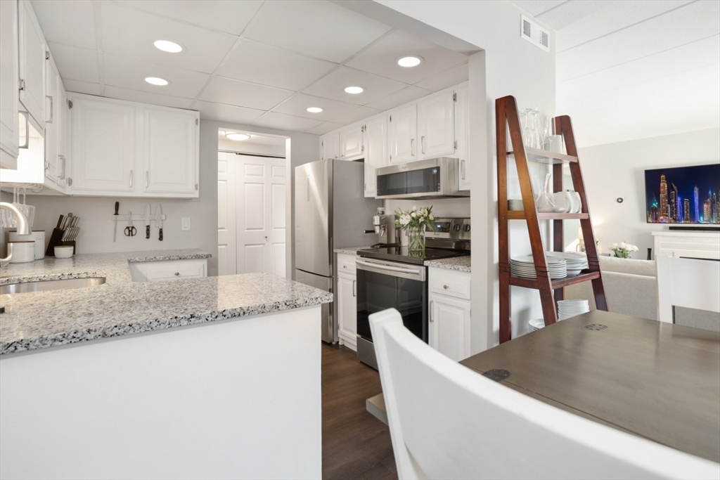 3 Ledgewood Way, Unit 8 Peabody, MA 01960 - Photo 12 of 36 a kitchen with stainless steel appliances granite countertop a refrigerator sink and stove