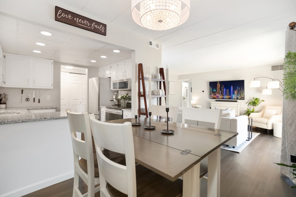 3 Ledgewood Way, Unit 8 Peabody, MA 01960 - Photo 14 of 36 a view of a dining room with furniture and wooden floor