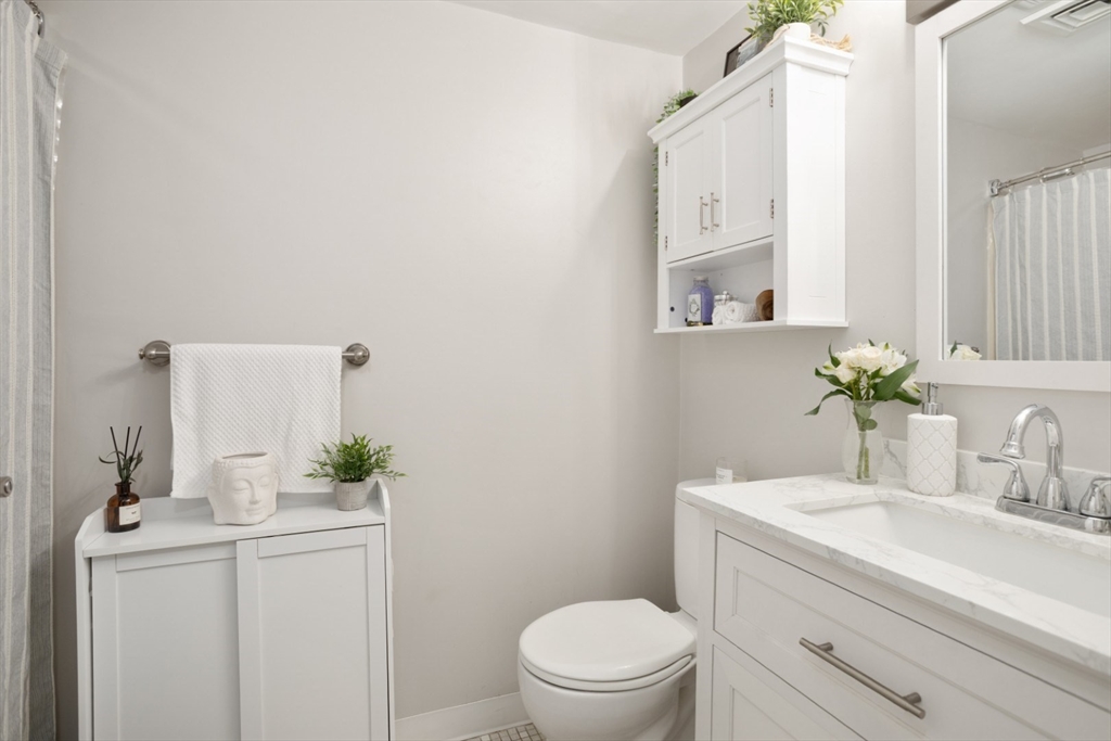 3 Ledgewood Way, Unit 8 Peabody, MA 01960 - Photo 18 of 36 a bathroom with a sink a toilet and mirror