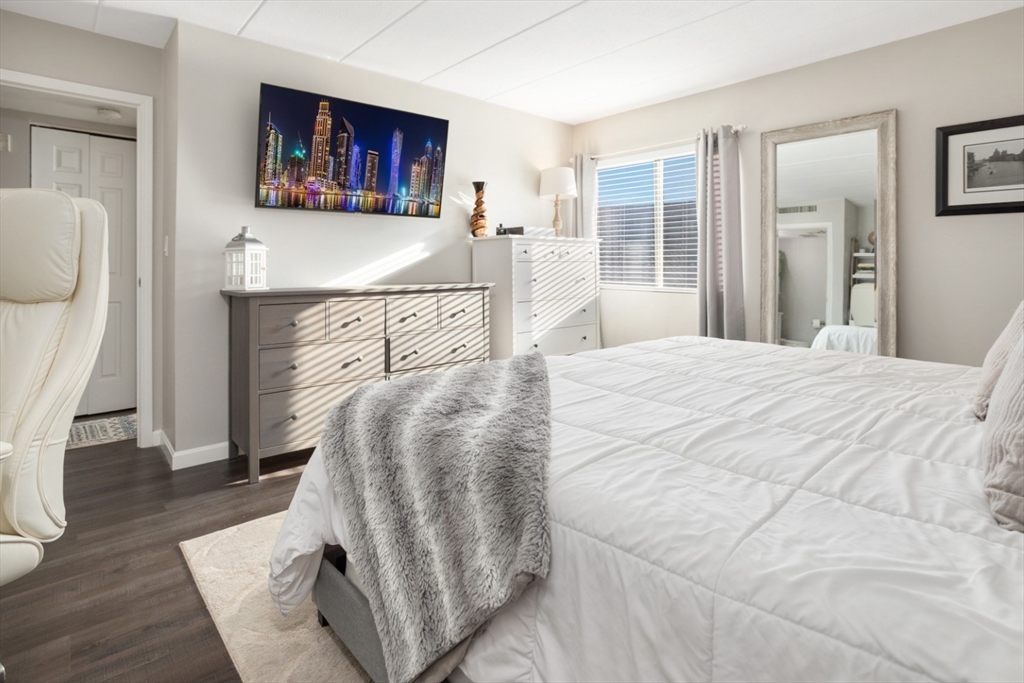 3 Ledgewood Way, Unit 8 Peabody, MA 01960 - Photo 19 of 36 a bedroom with a bed and a couch