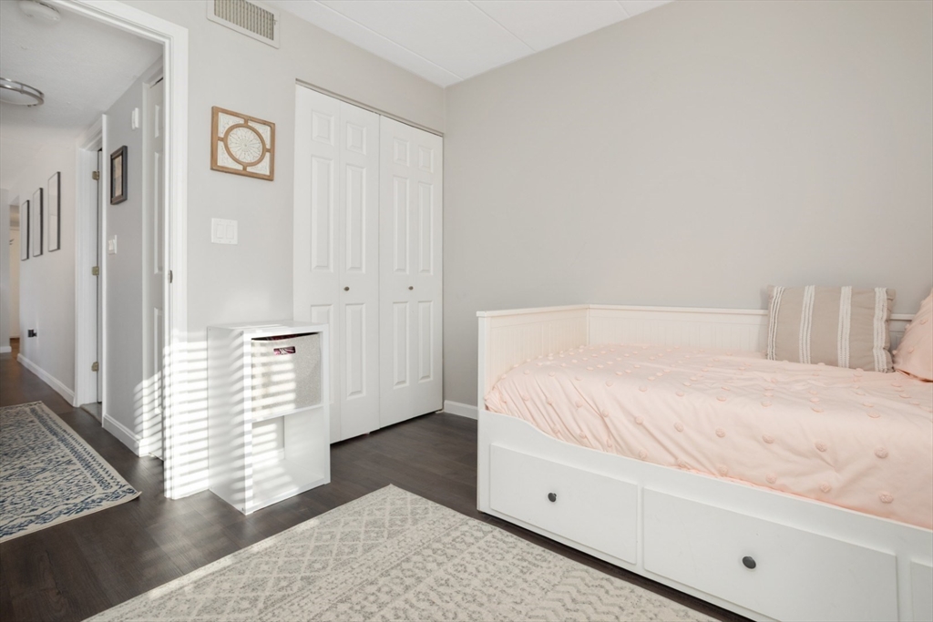 3 Ledgewood Way, Unit 8 Peabody, MA 01960 - Photo 23 of 36 a bedroom with a bed and a window