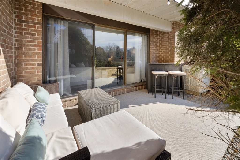 3 Ledgewood Way, Unit 8 Peabody, MA 01960 - Photo 26 of 36 a living room with furniture and a large window