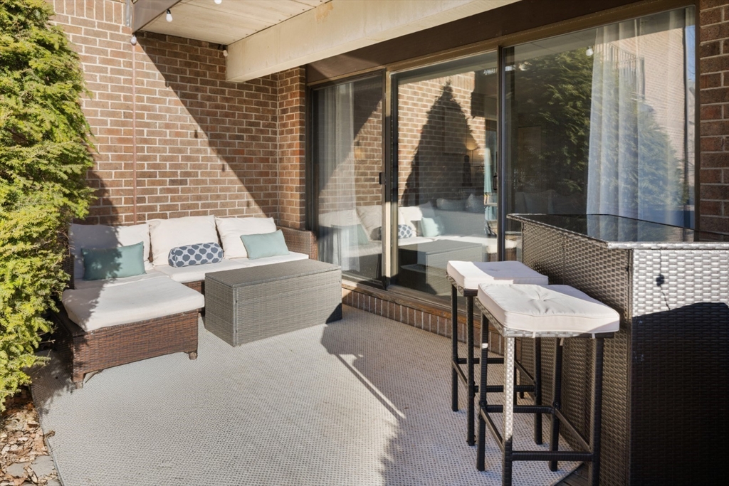 3 Ledgewood Way, Unit 8 Peabody, MA 01960 - Photo 27 of 36 a living room with furniture and large windows