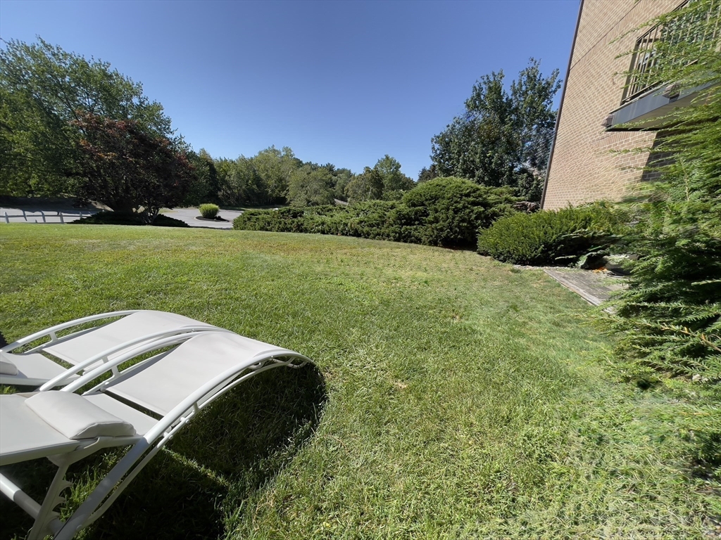 3 Ledgewood Way, Unit 8 Peabody, MA 01960 - Photo 29 of 36 a view of a backyard with a garden