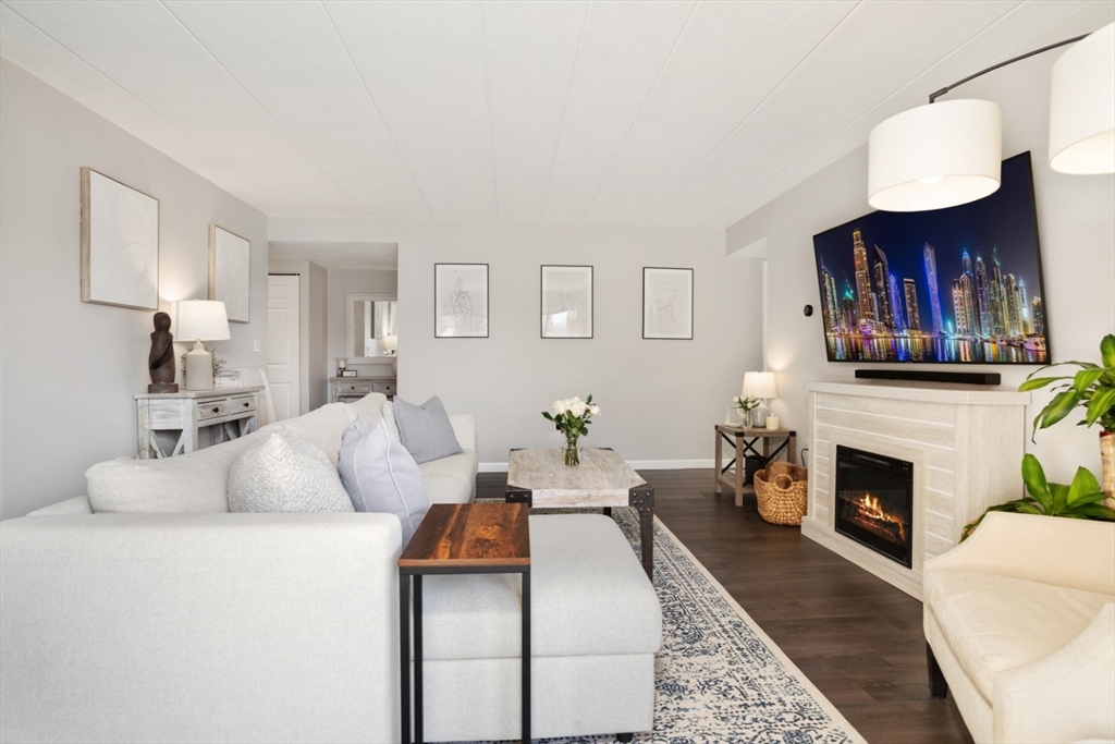 3 Ledgewood Way, Unit 8 Peabody, MA 01960 - Photo 3 of 36 a living room with furniture and a fireplace
