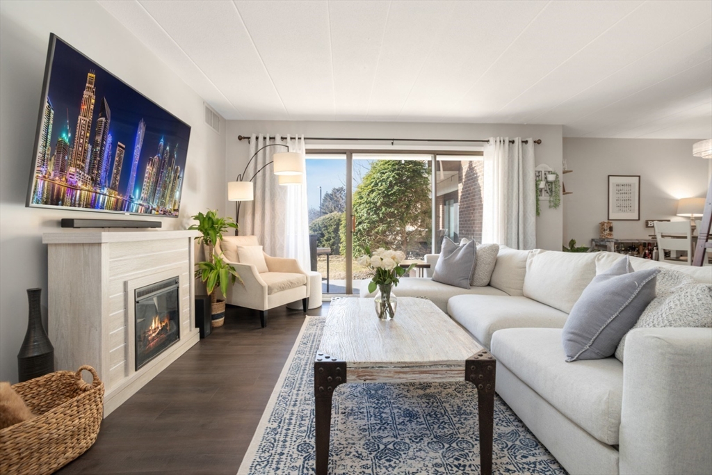 3 Ledgewood Way, Unit 8 Peabody, MA 01960 - Photo 5 of 36 a living room with furniture and a fireplace