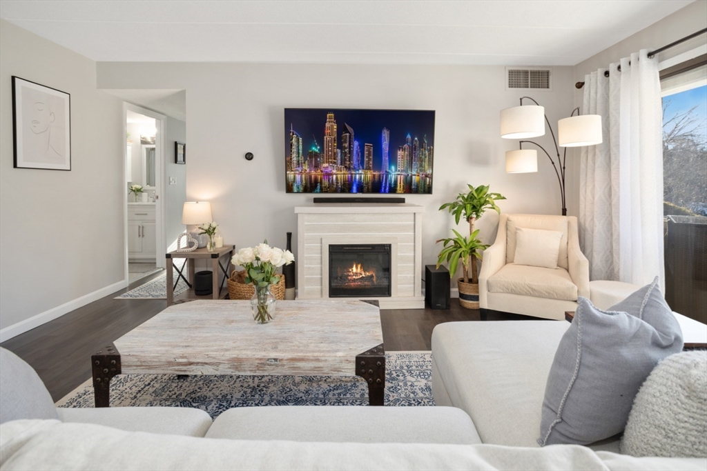 3 Ledgewood Way, Unit 8 Peabody, MA 01960 - Photo 6 of 36 a living room with furniture a fireplace and a large window
