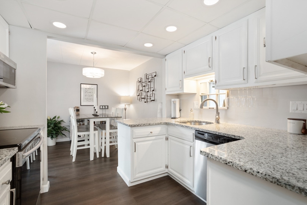 3 Ledgewood Way, Unit 8 Peabody, MA 01960 - Photo 9 of 36 a kitchen with white cabinets and sink
