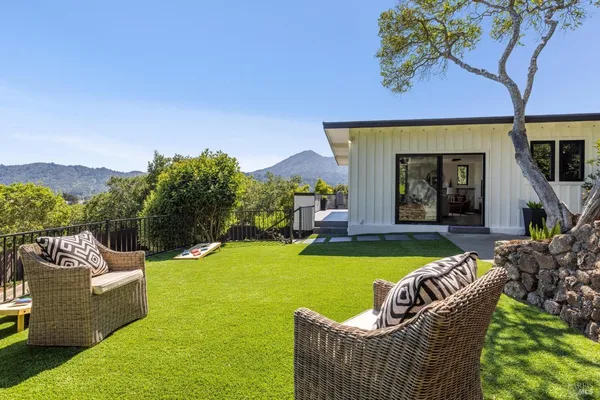 a view of a house with swimming pool and porch with furniture