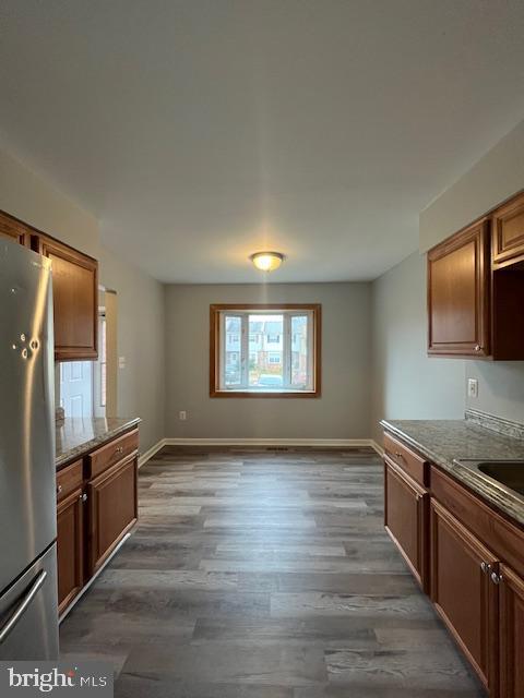 14811 Ensor Court Woodbridge, VA 22193 - Photo 5 of 34 a view of a kitchen with a sink stove top oven and wooden floor