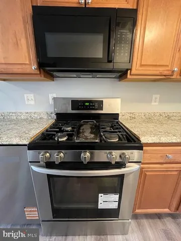 a stove top oven sitting inside of a kitchen