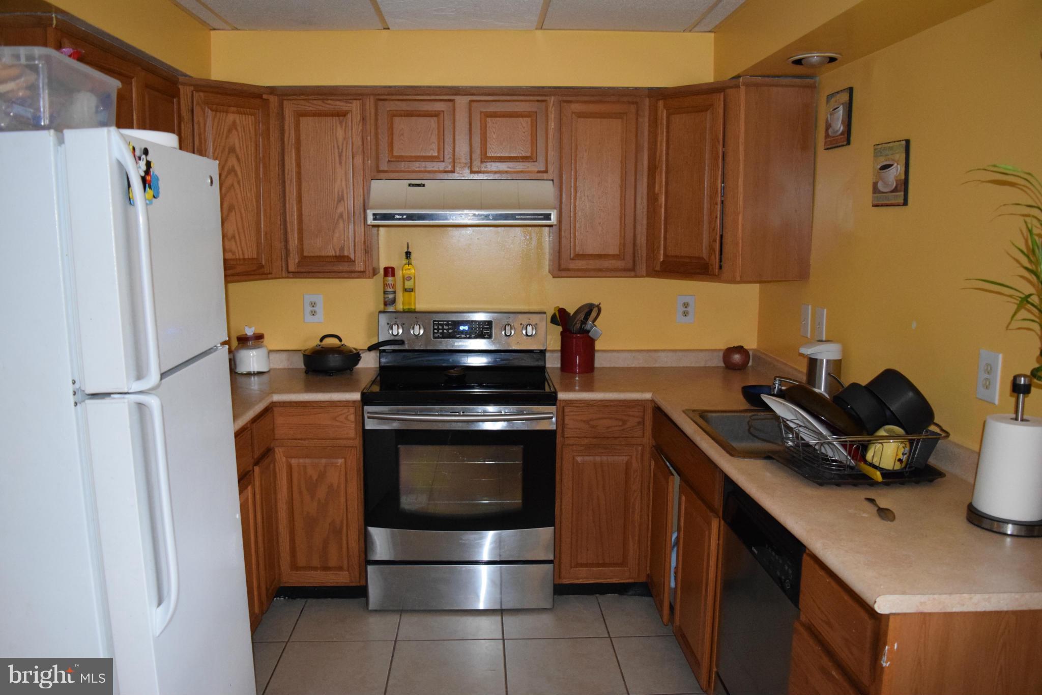 3436 Bruton Parish Way, Unit 25 Silver Spring, MD 20904 - Photo 3 of 6 a kitchen with a refrigerator stove and cabinets
