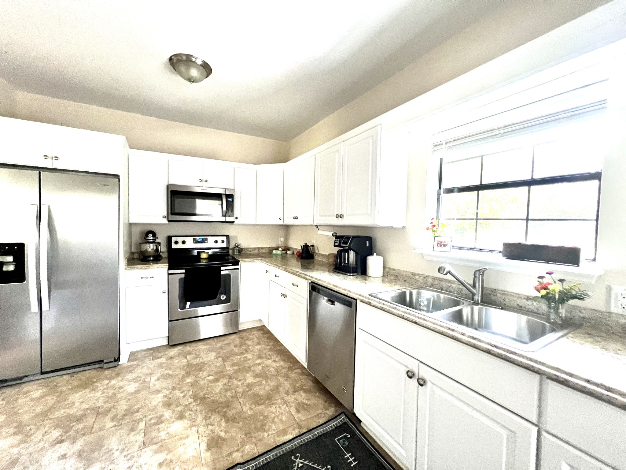 639 Neelys Bend Road Madison, TN 37115 - Photo 9 of 16 a kitchen with refrigerator cabinets and a sink