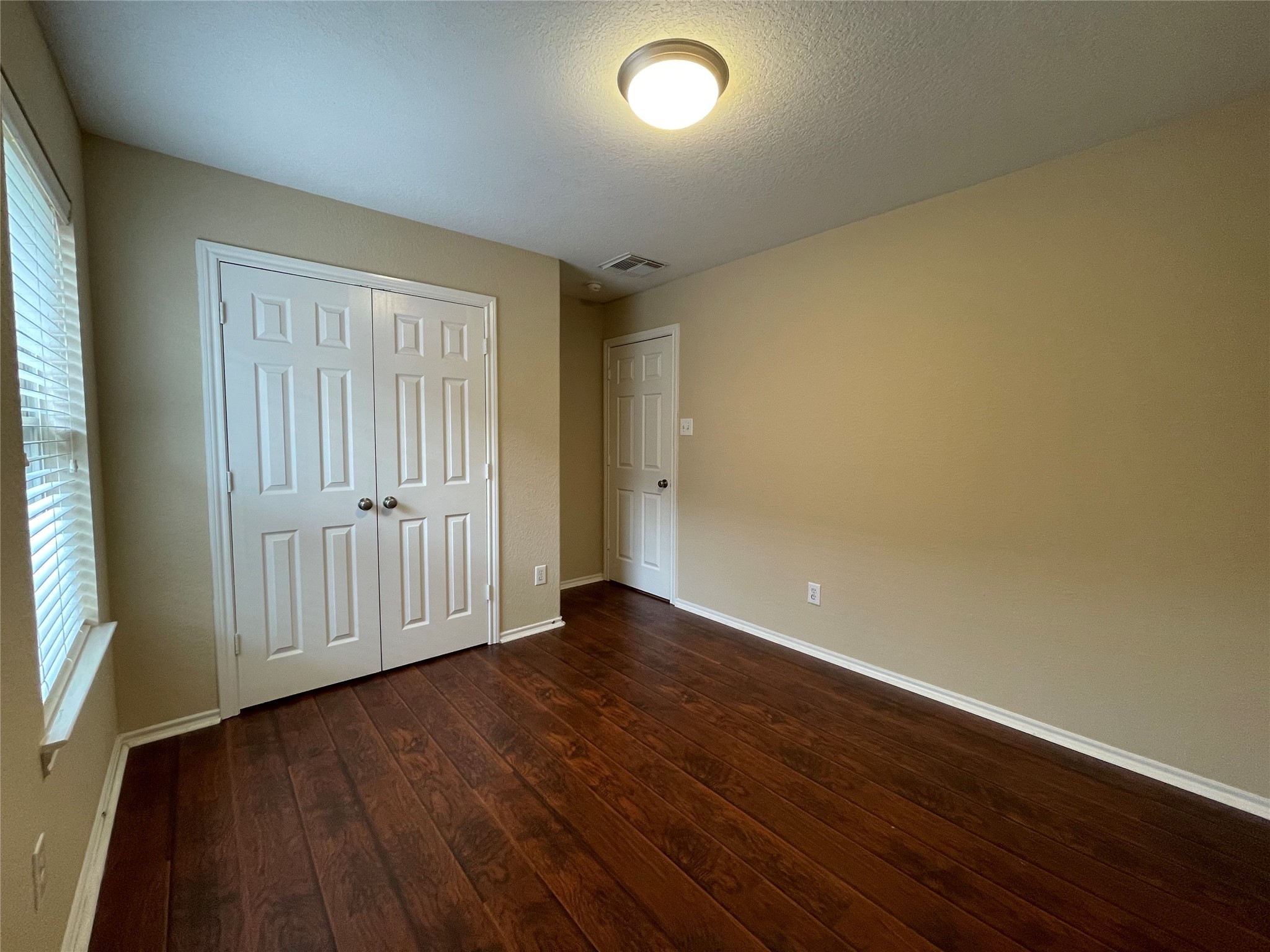 6110 Moran Crest Drive Spring, TX 77388 - Photo 12 of 49 an empty room with wooden floor and windows