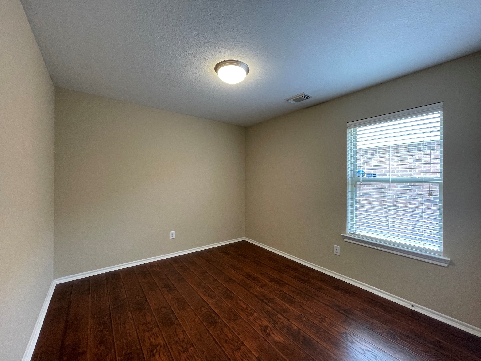 6110 Moran Crest Drive Spring, TX 77388 - Photo 15 of 49 an empty room with wooden floor and windows