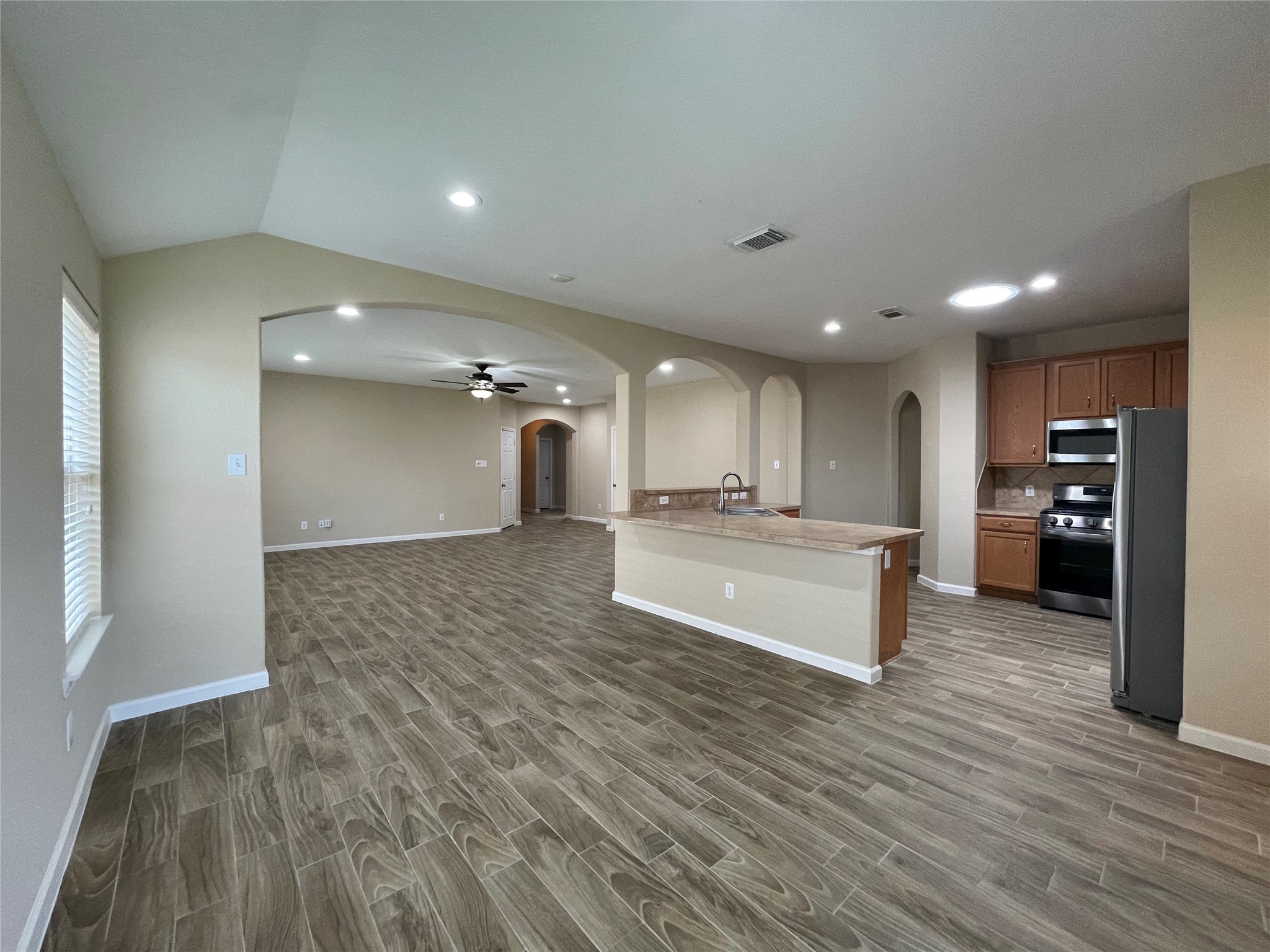 6110 Moran Crest Drive Spring, TX 77388 - Photo 19 of 49 a view of kitchen with kitchen island a sink wooden floor and a refrigerator