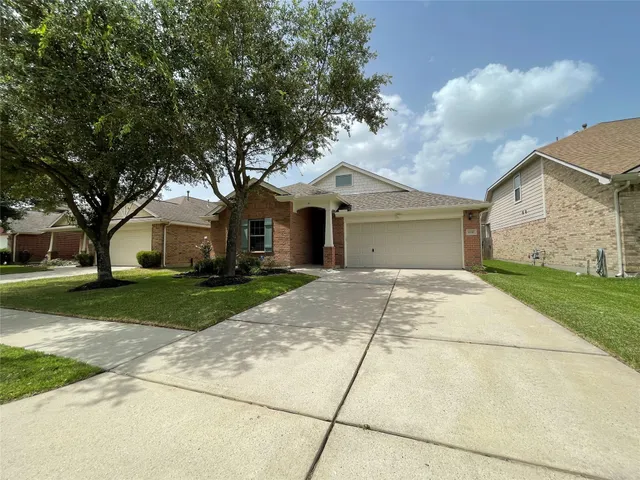 a front view of a house with a yard and trees
