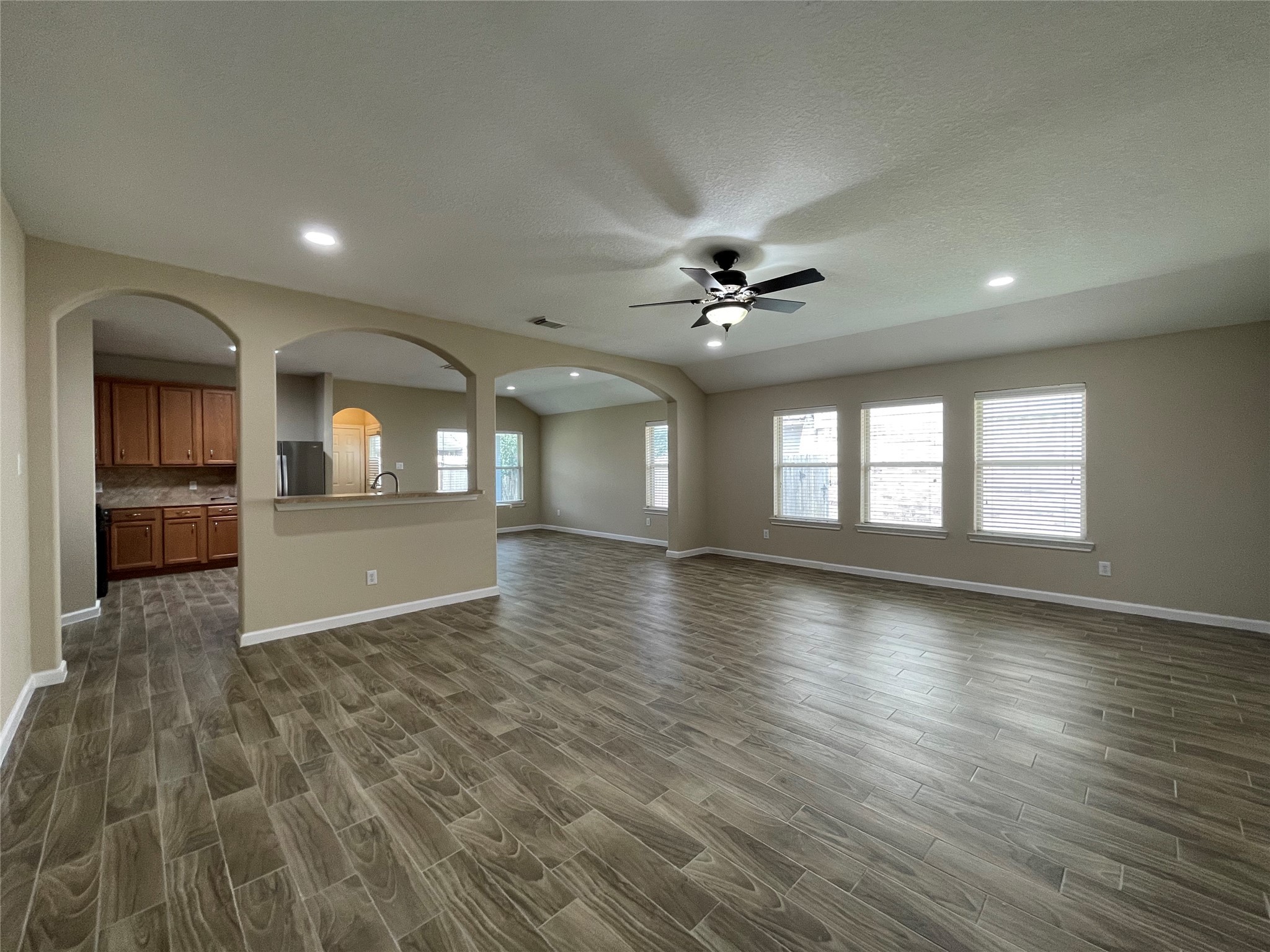 6110 Moran Crest Drive Spring, TX 77388 - Photo 24 of 49 an empty room with wooden floor and windows