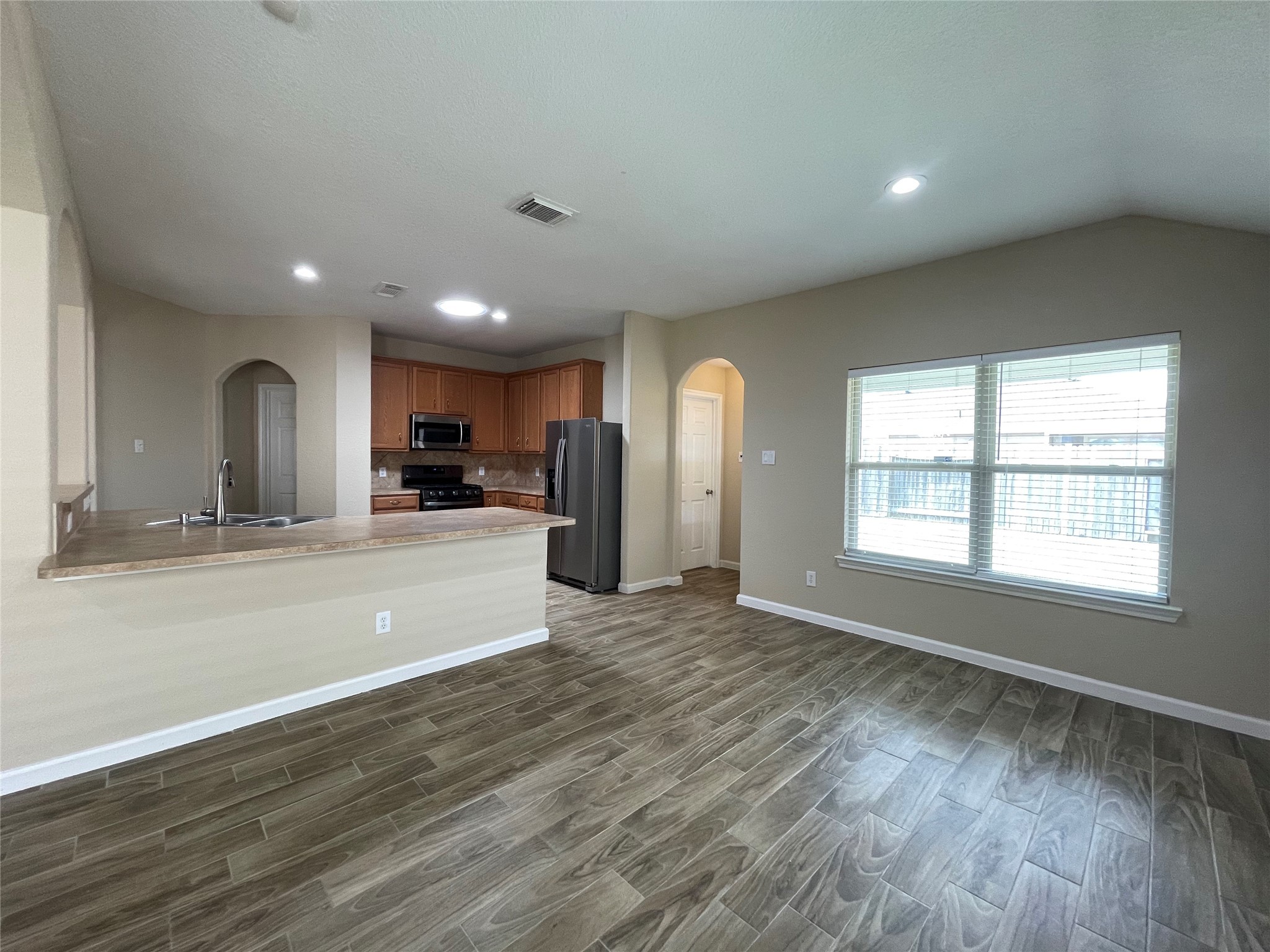6110 Moran Crest Drive Spring, TX 77388 - Photo 25 of 49 an empty room with wooden floor and windows