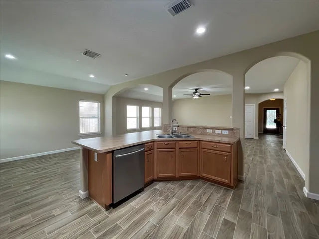 a view of a kitchen counter top space and wooden floor