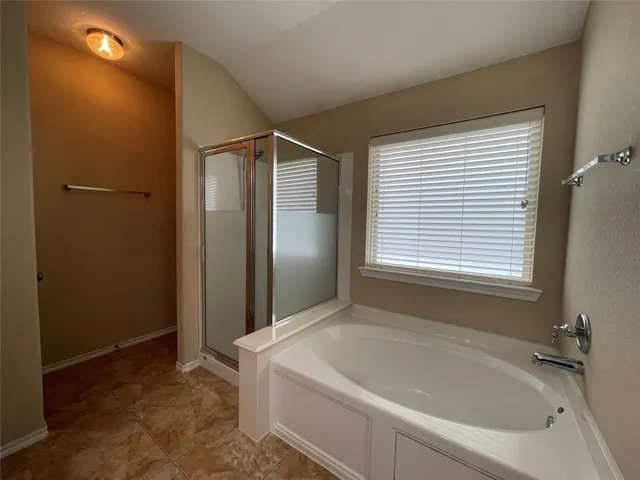 a bathroom with a bathtub and a shower
