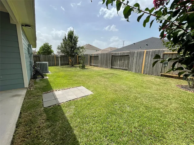 a view of a backyard with table and chairs and potted plants