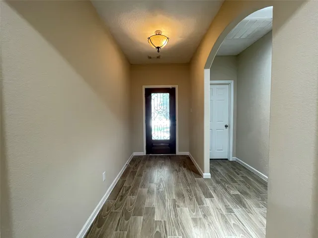 a view of a room with a window and wooden floor