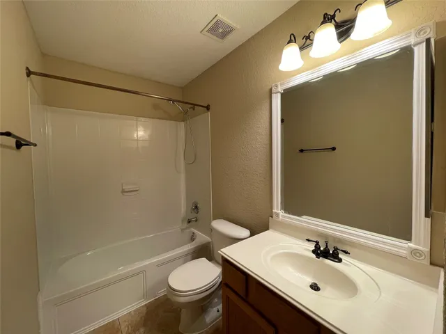 a bathroom with a sink mirror toilet and bathtub