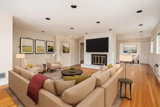 a living room with furniture a fireplace and a flat screen tv