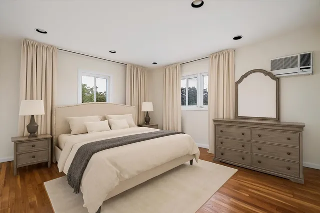 a bedroom with a large bed and a dresser