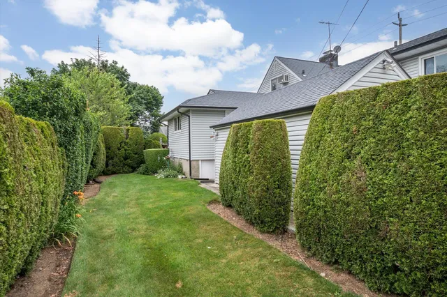 a view of a house with a small yard and plants