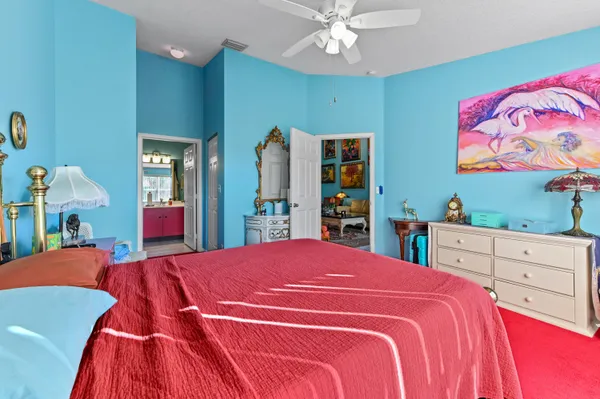 a bedroom with a large bed and a dresser